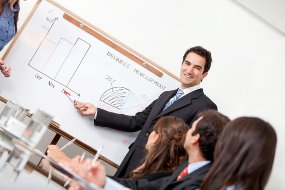 Man in a business meeting displaying the performance of the company