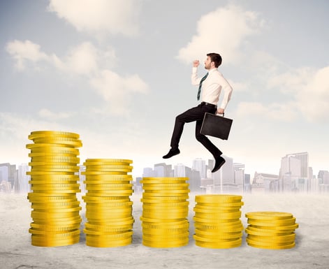 Successful business man jumping up on gold coin money concept